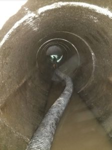 Worker inside the pipe, after clearing obstruction
